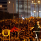 Joshua Wong, leader of the student movement, delivers a speech as protesters block the main street to the financial Central district, outside the government headquarters building in Hong Kong October 1, 2014. Thousands of pro-democracy protesters thronged the streets of Hong Kong on Wednesday, some of them jeering National Day celebrations, and students threatened to ramp up demonstrations if the city's pro-Beijing leader did not step down. REUTERS/Carlos Barria (CHINA - Tags: POLITICS CIVIL UNREST) - RTR48IL1